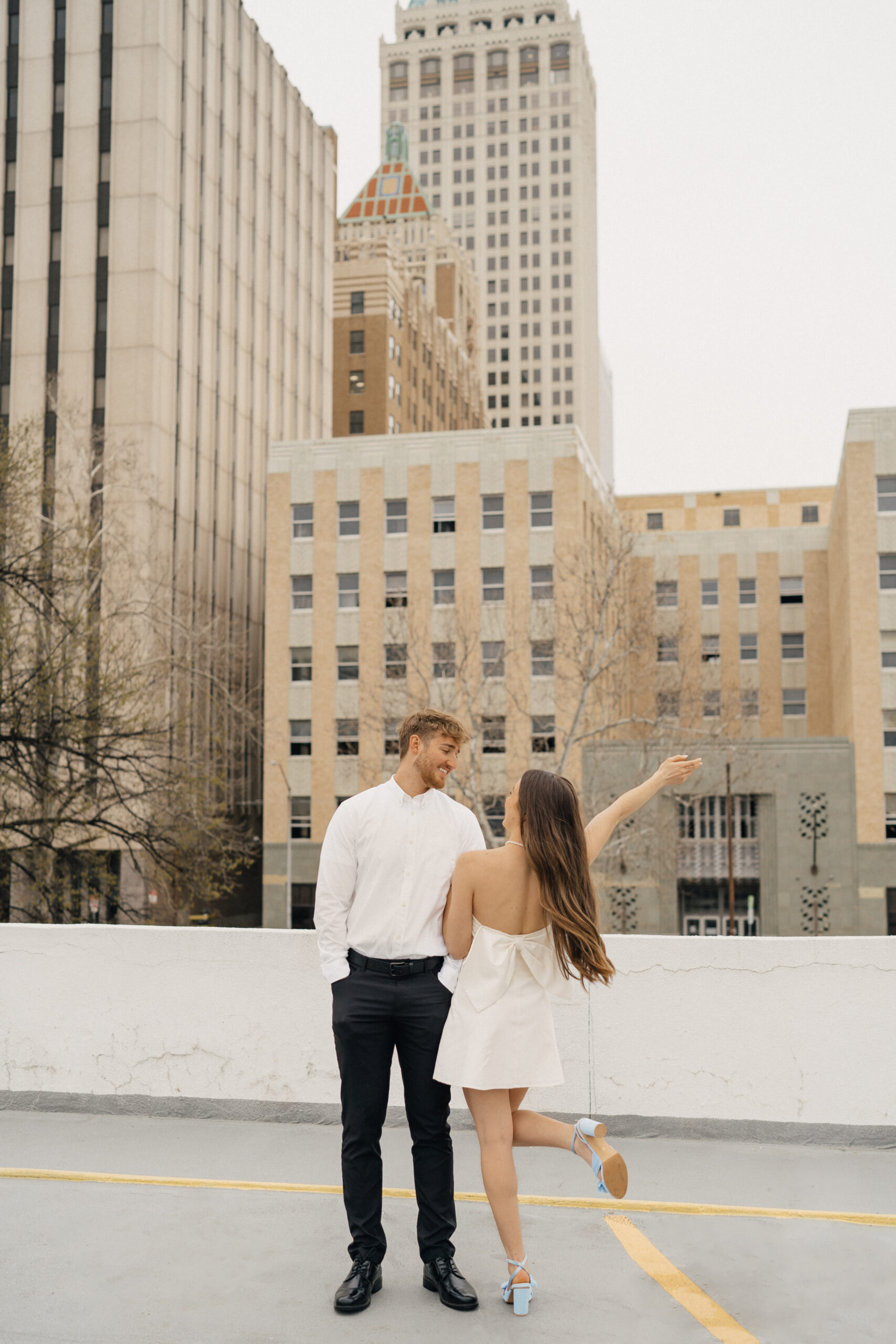 Beach engagement session outfit ideas with couple barefoot in swimsuits