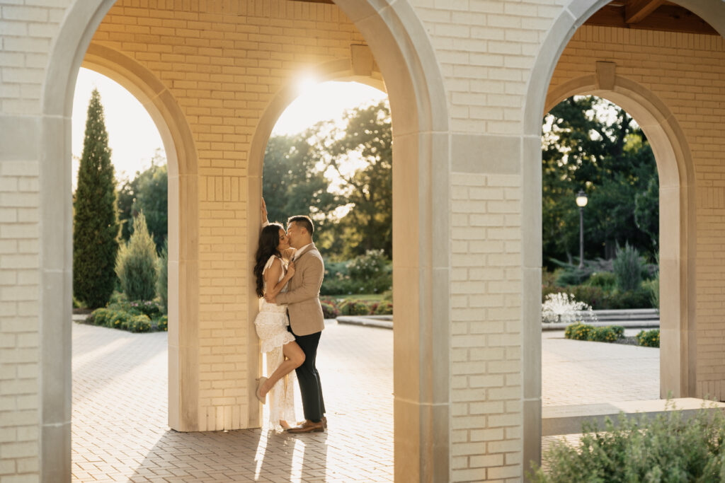 Engagement session surrounded by flowers and greenery at Woodward Park