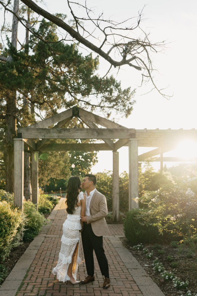 Romantic engagement photos under blooming trees at Woodward Park in Tulsa