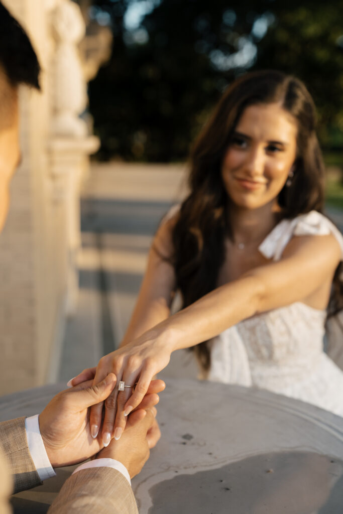 Sweet candid moment during engagement photos at Woodward Park’s gardens