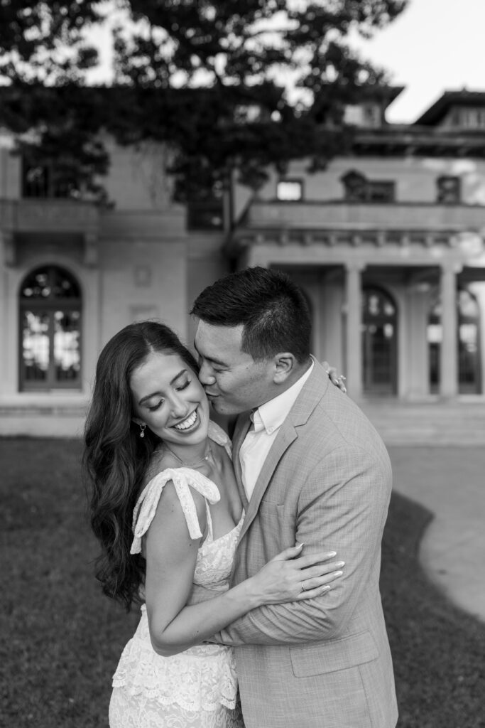 Joyful engagement session surrounded by fountains and greenery at The Mansion at Woodward Park