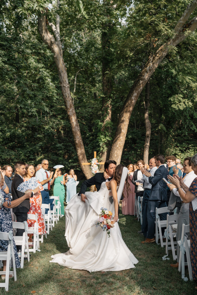Hands holding a camera while adjusting settings before a session