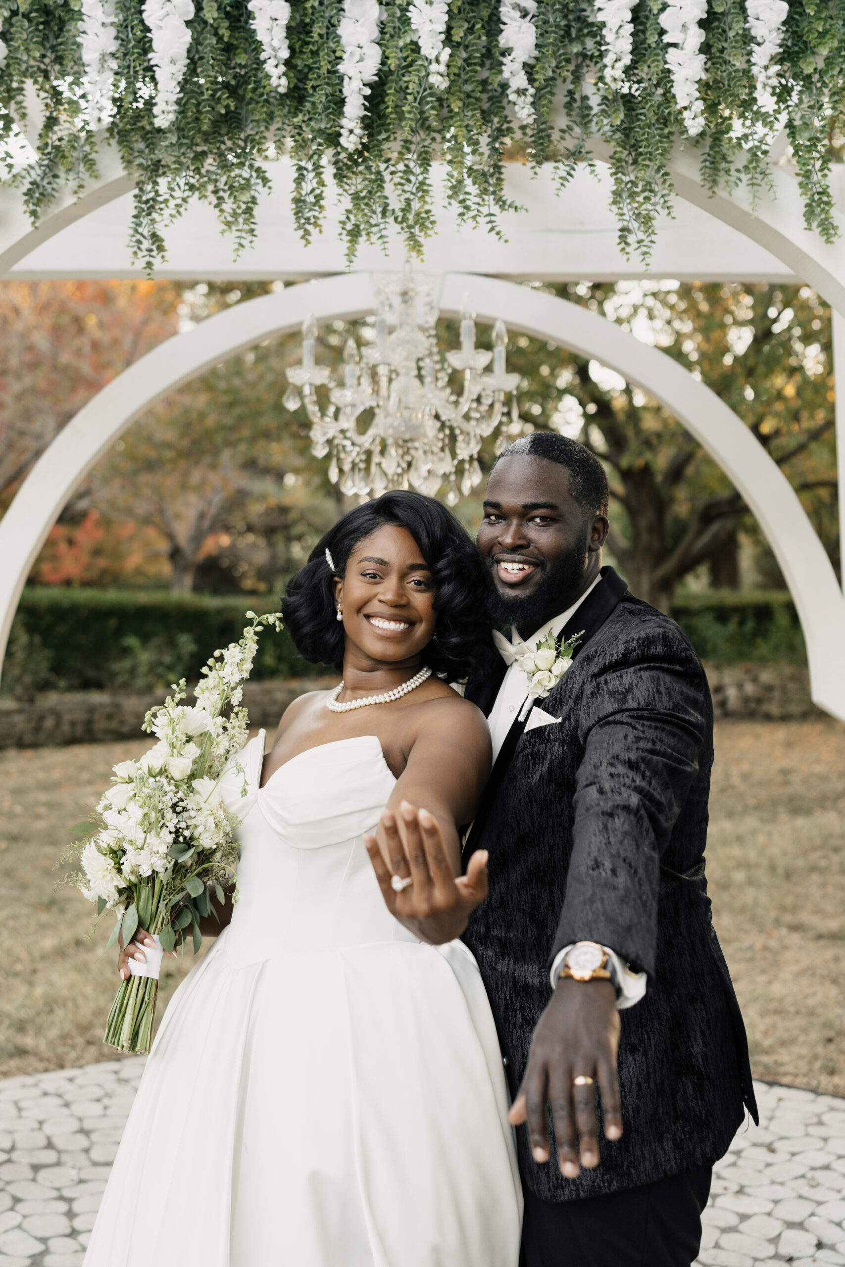 Intimate newlywed moment beneath pergola at Haseltine Estate