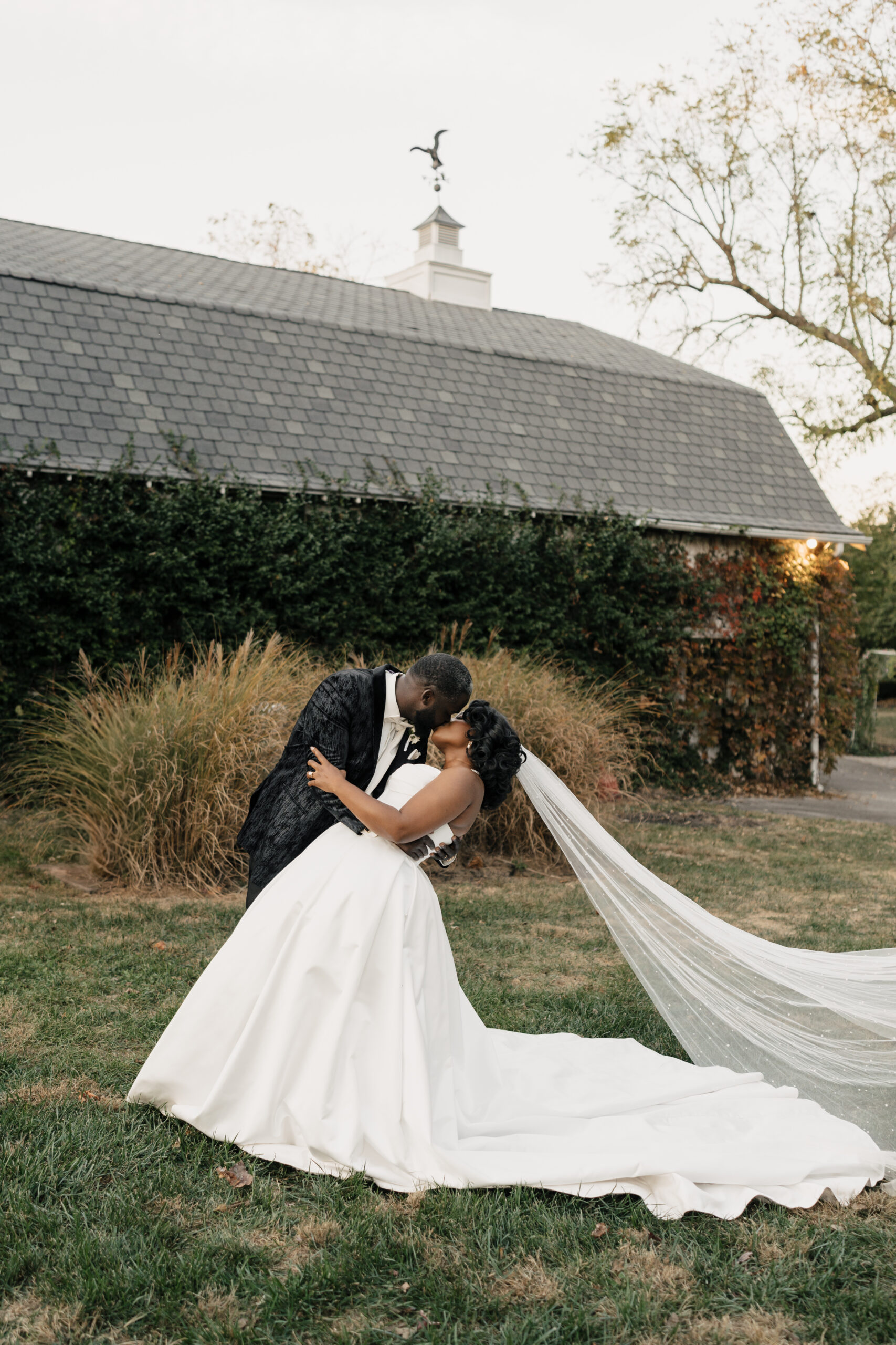 Bride in cathedral veil twirling in garden courtyard