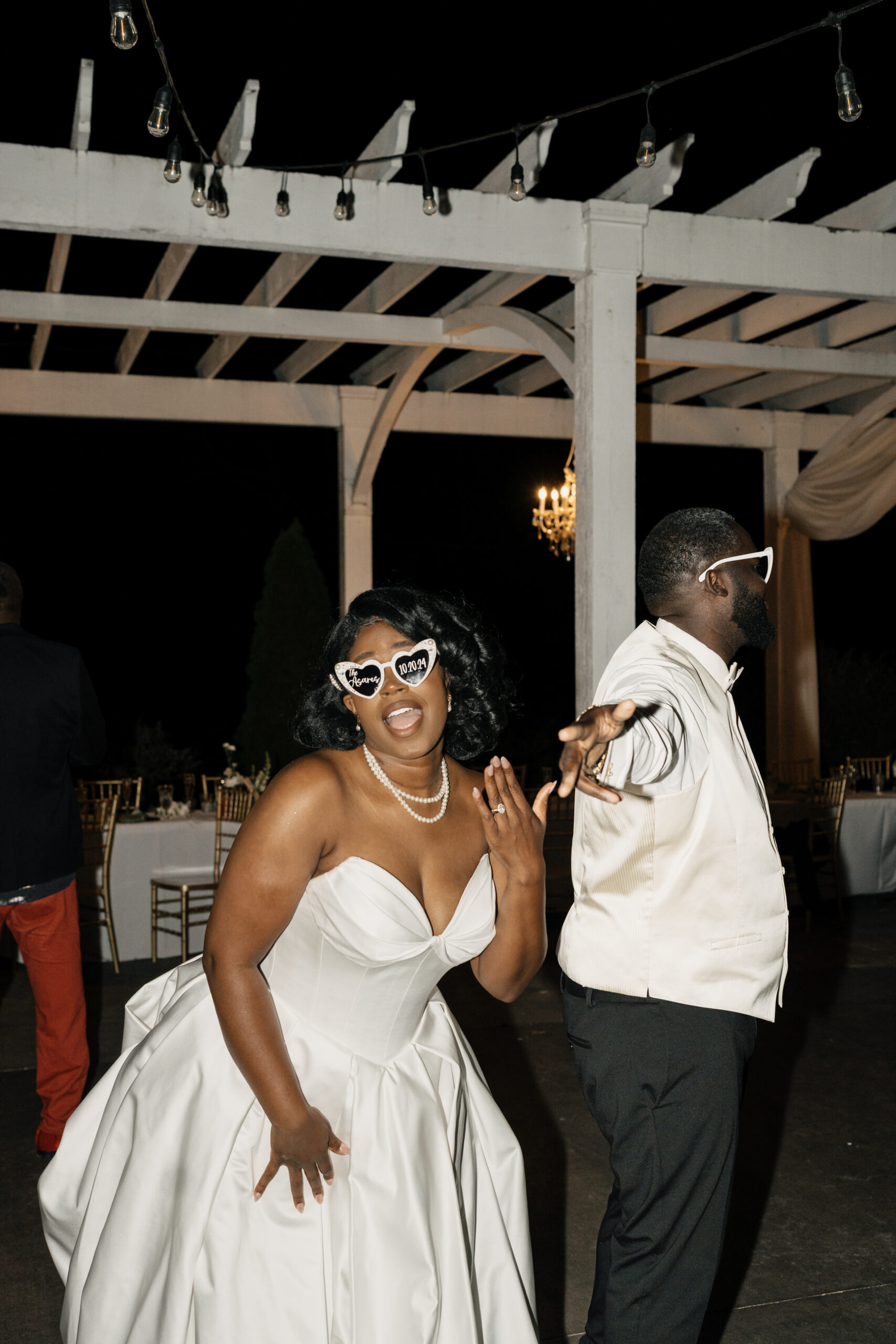 Couple dancing under string lights at Italy destination wedding