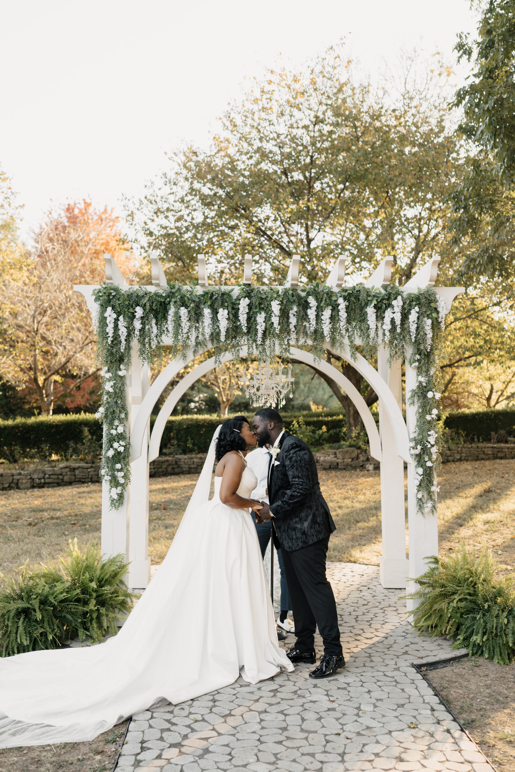 Italy-style wedding altar decorated with white roses and greenery