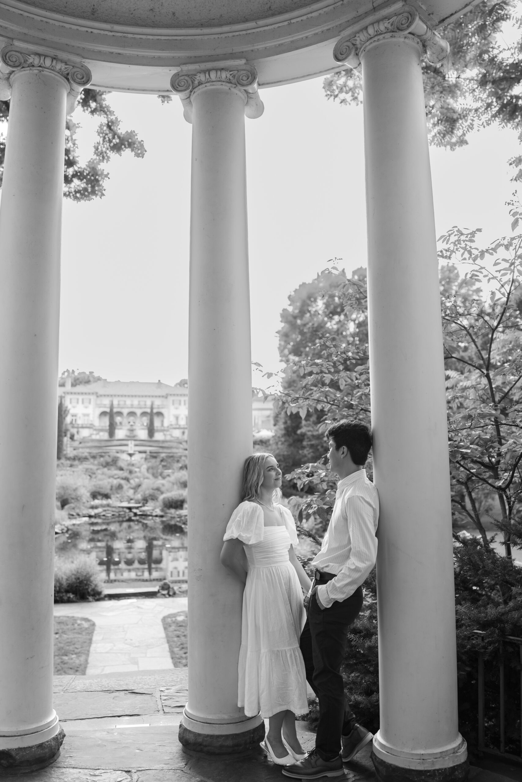 Romantic Tulsa engagement photos in front of Philbrook Museum mansion and fountains.