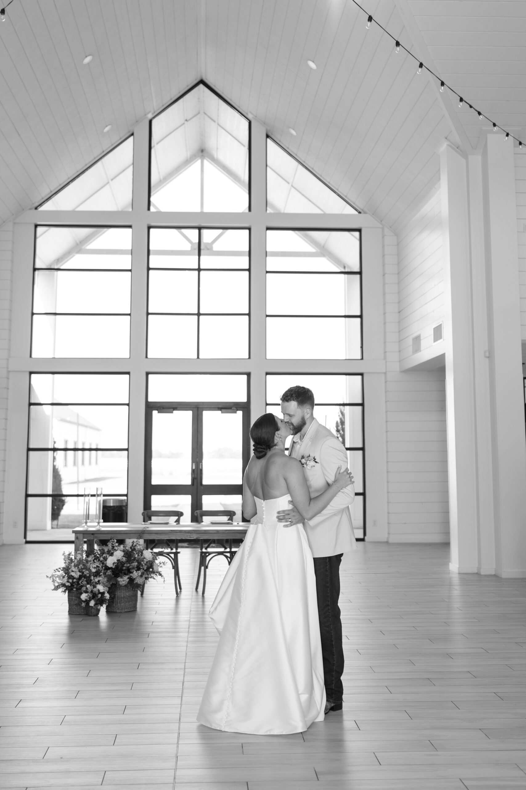 Bright and airy reception space inside The Gardenia wedding venue in Texas with large windows and neutral decor. 