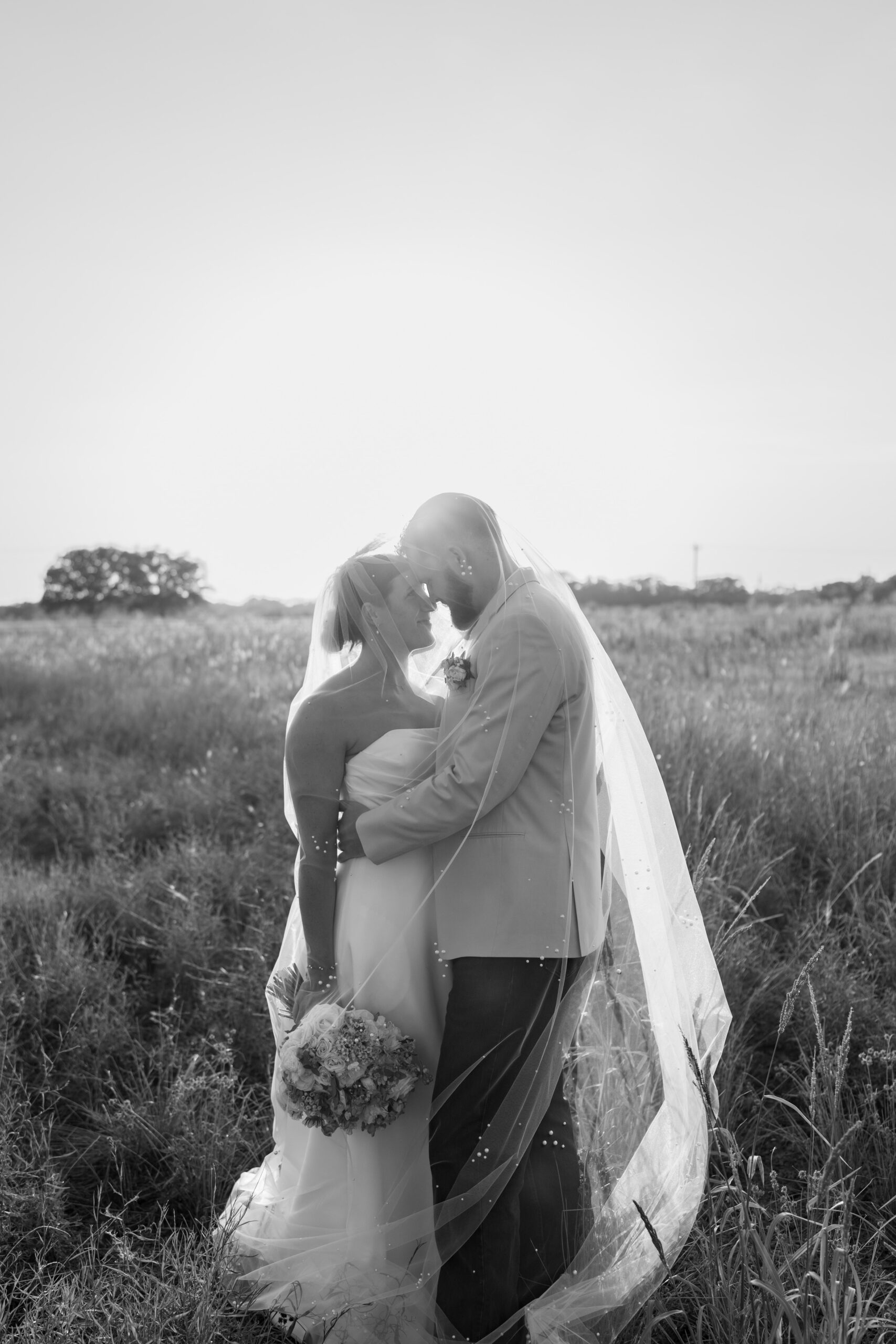 Photographer holding camera during golden hour outdoor shoot