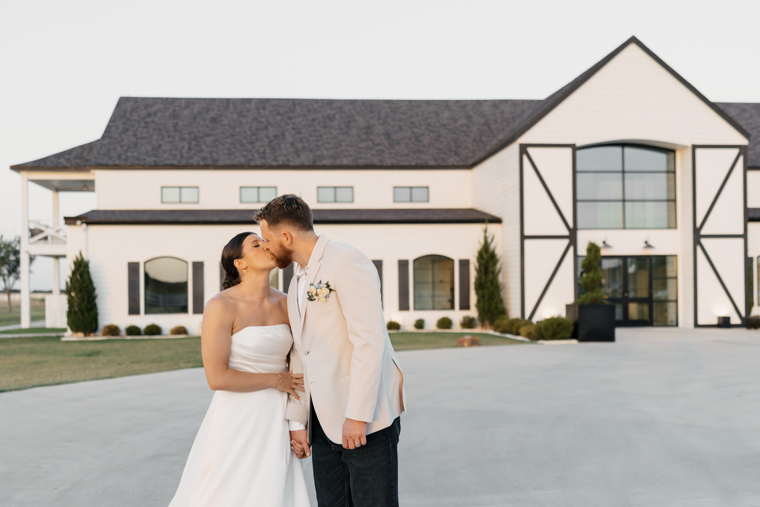Couple walking hand in hand across the lawn at The Gardenia in Texas.