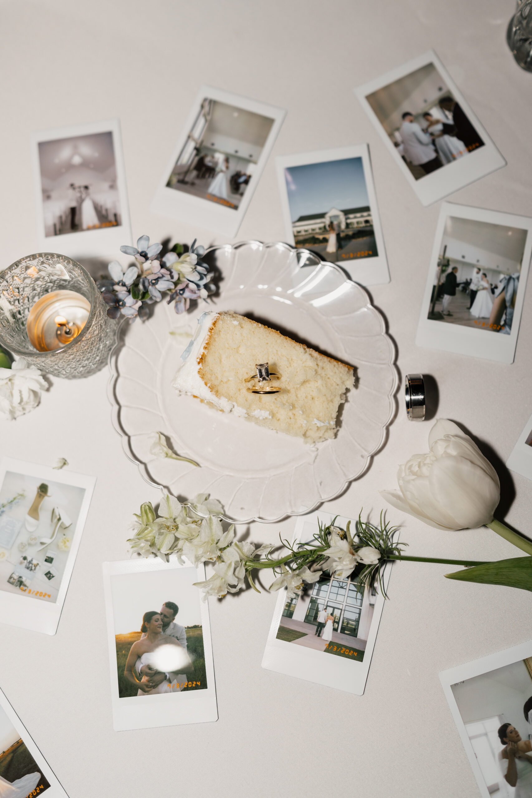 Table setup with floral centerpieces and candles inside The Gardenia wedding venue in Texas.