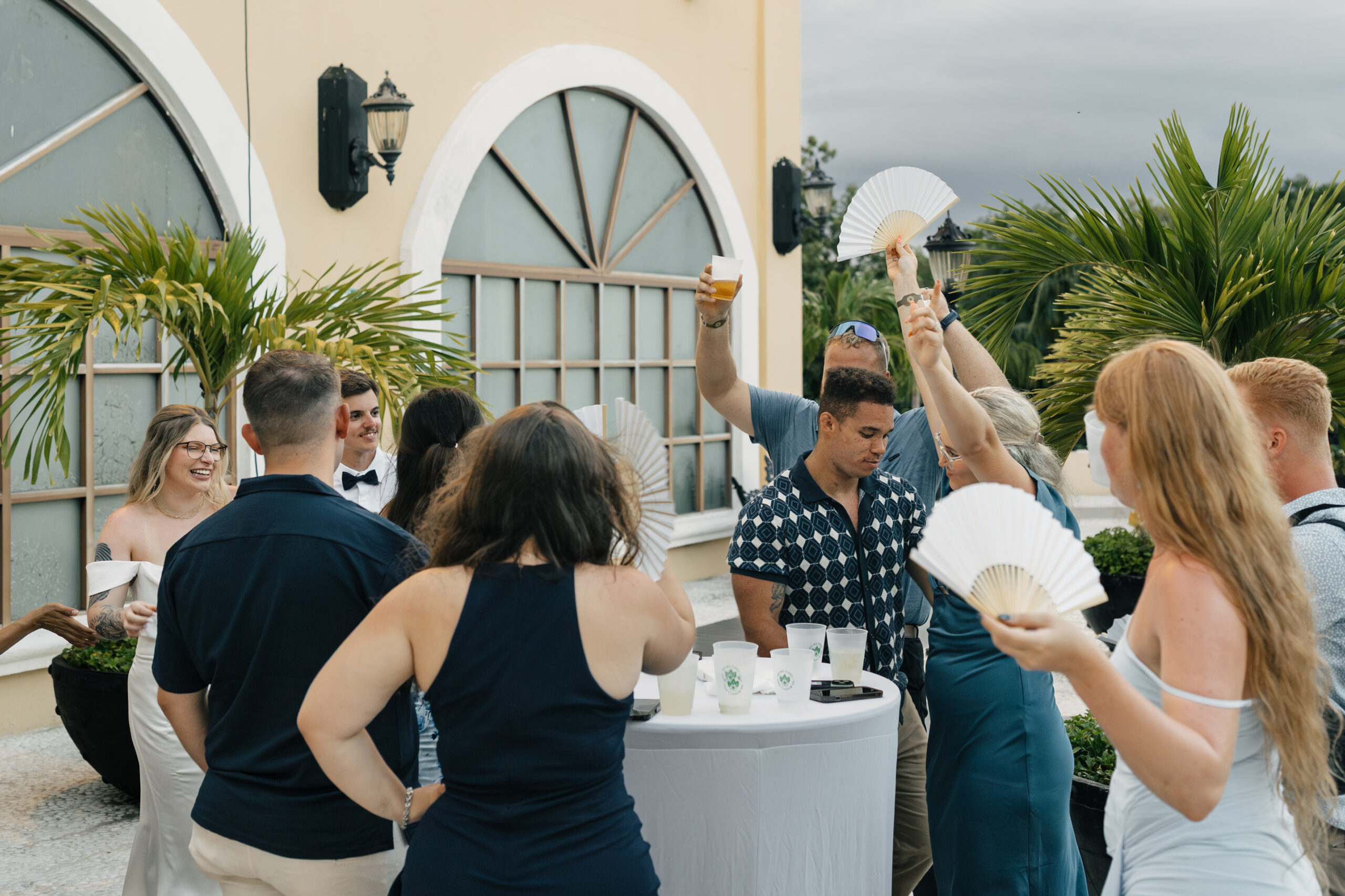 Wedding guests enjoying drinks near ocean view