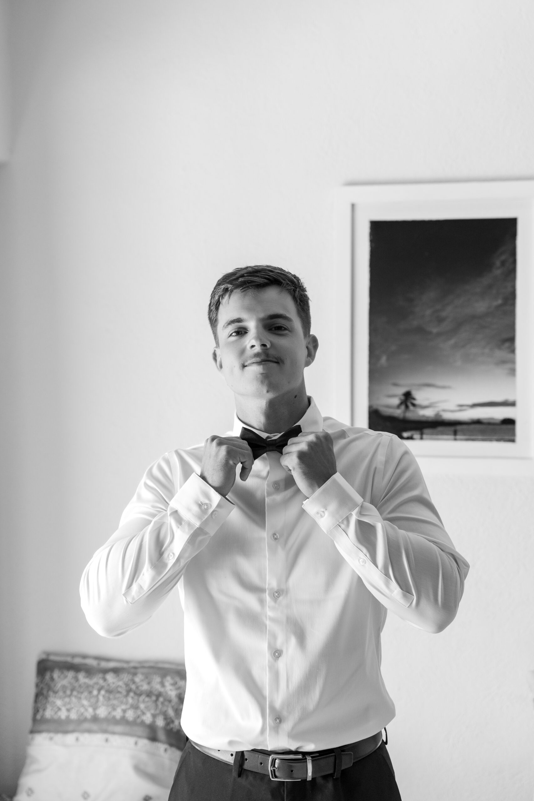 Groom adjusting tie for destination wedding in Mexico 