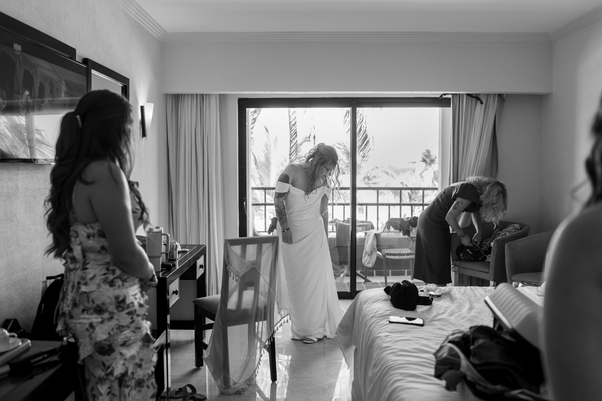 Bridesmaids helping bride get ready at destination wedding