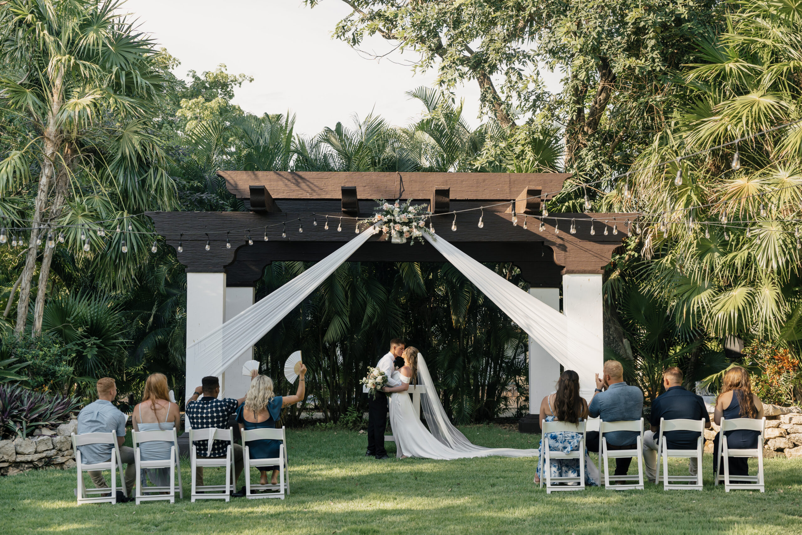 First kiss as newlyweds at Sandos Playacar wedding