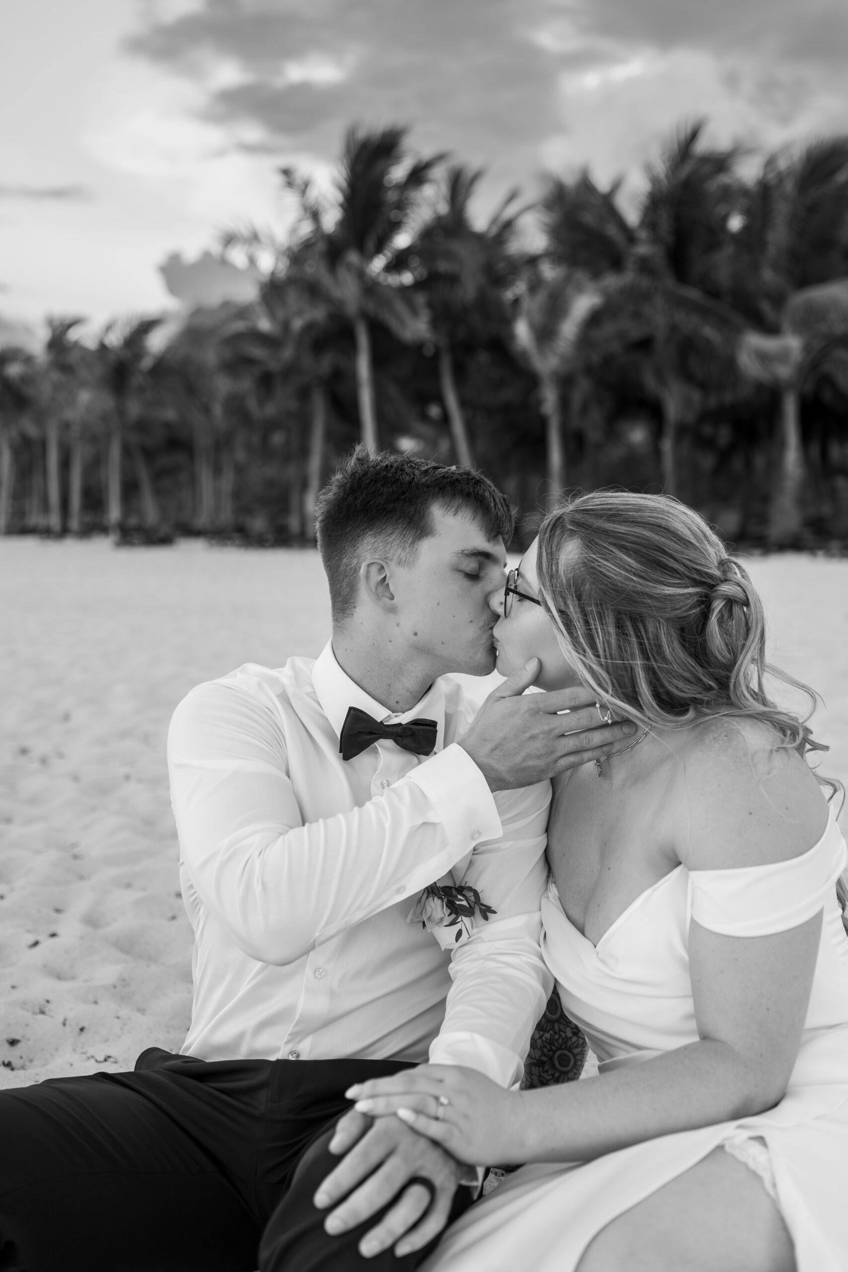 Bride and groom sharing quiet moment by ocean