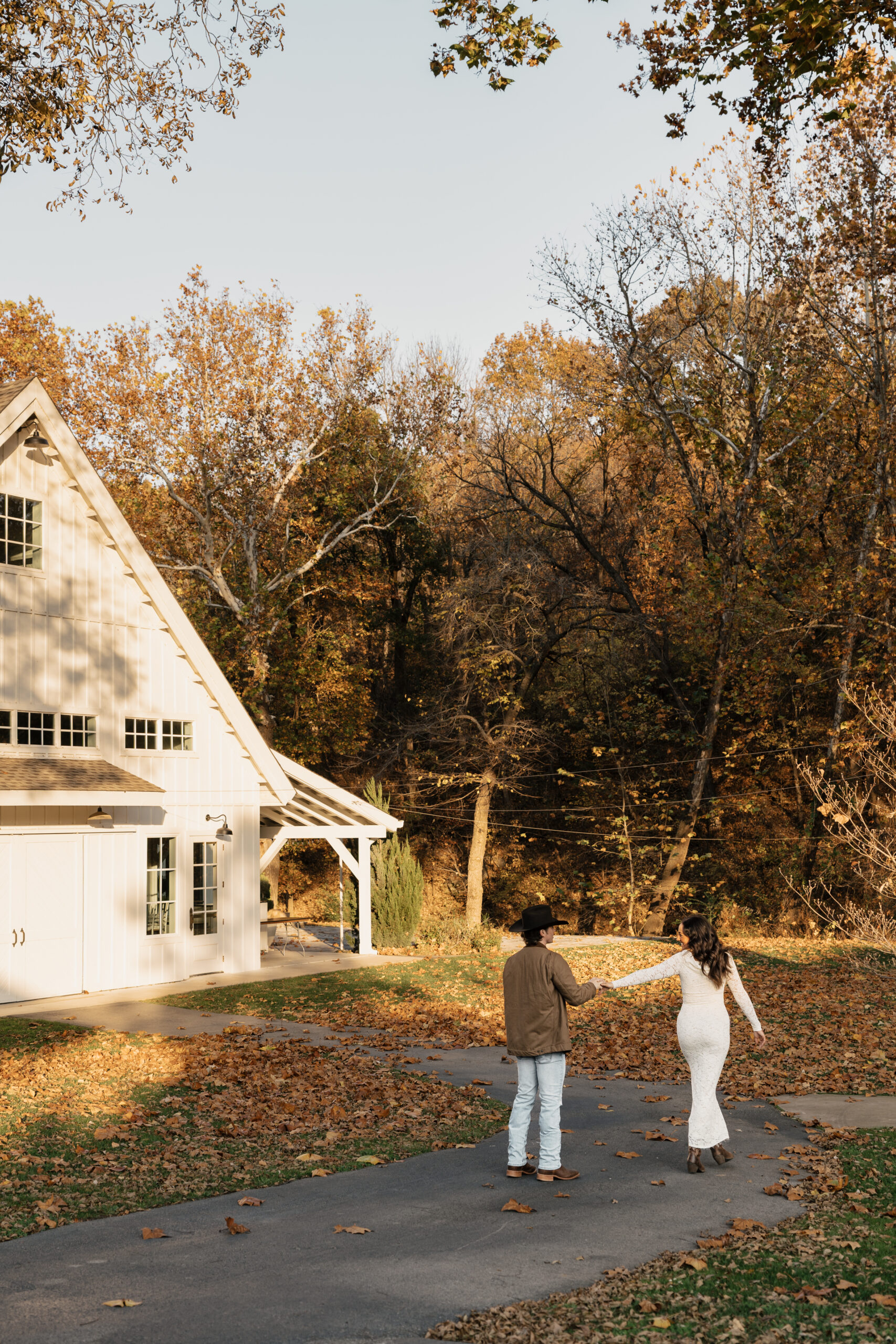Groom spinning his fiancée under golden hour light at their engagement session