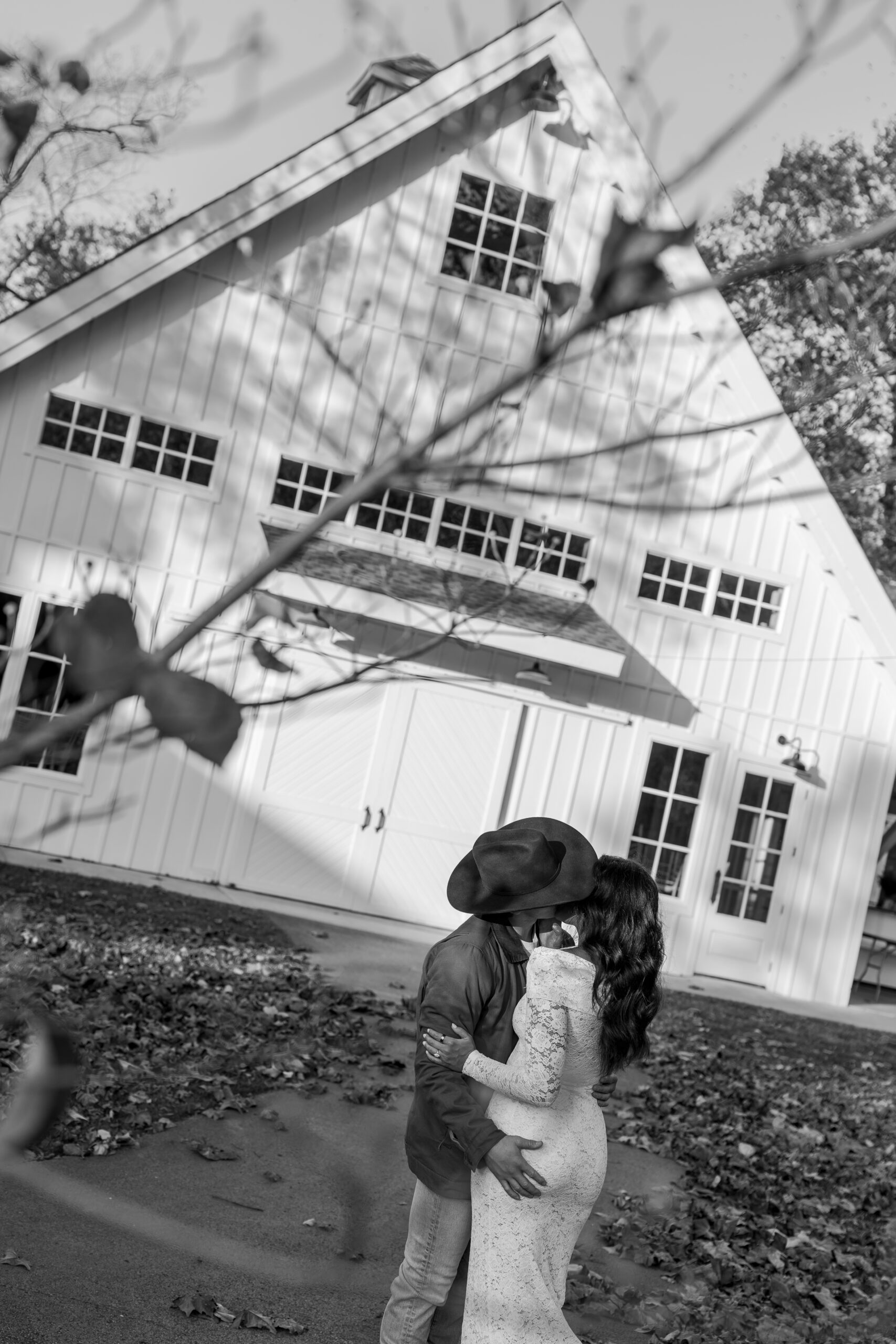 Engagement photo with fall leaves and tall grass, capturing playful and natural interaction