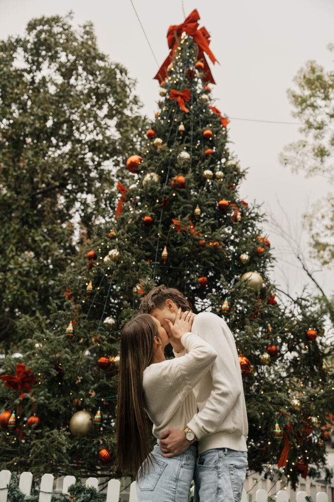 Romantic kiss under Christmas lights Tulsa