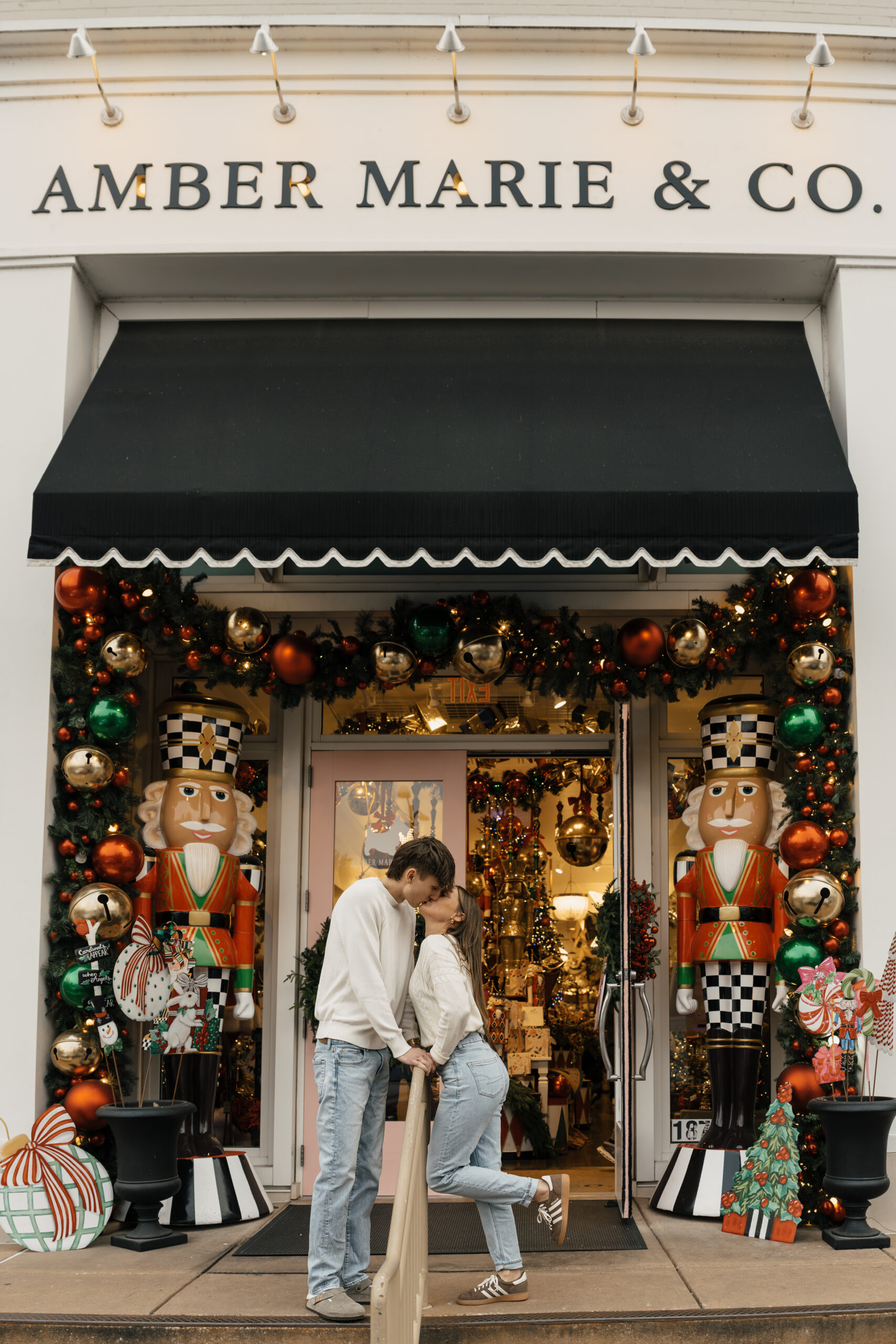 Couple standing outside festive Utica Square storefront