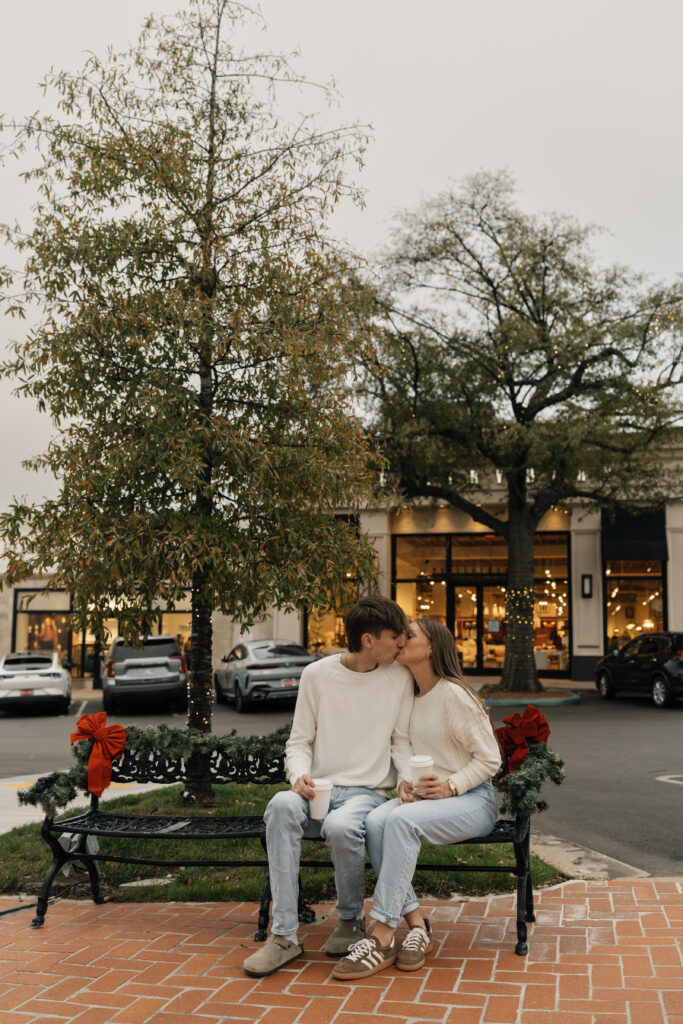 ouple sitting on festive bench under twinkling lights in Utica Square