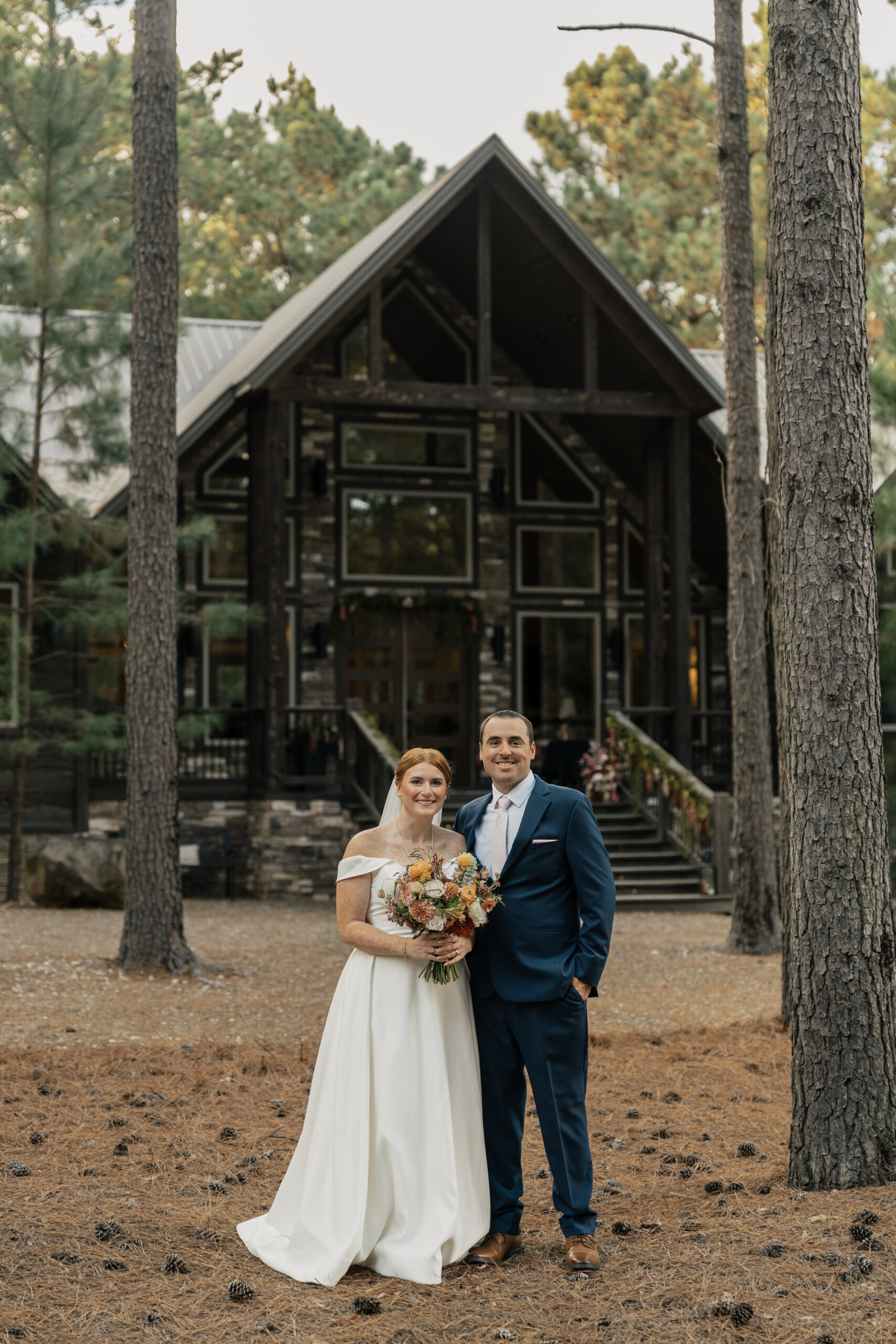 Couple during a Broken Bow elopement with lake and forest background